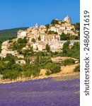 The Provence hilltop village of Simiane-la-Rotonde in summer with lavender field. Albion Plateau in Alpes-de-Hautes-Provence, France