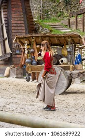 PROVINS, FRANCE - MARCH 31, 2018: Unidentified beautiful girl in red during the medieval reconstruction of Legend of the Knights - Shutterstock ID 1061689922