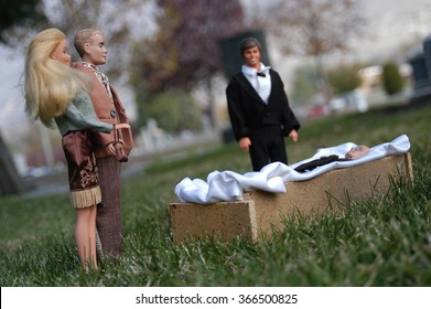 Provo, UT, USA - November 7, 2004: Barbie dolls gather at the cemetery around the open casket, attending Ken's funeral.