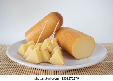 Provolone Cheese On A Plate On A White Background