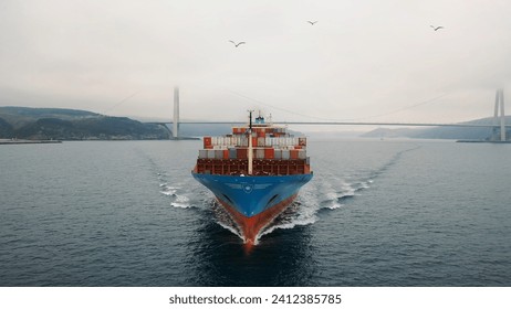 Prow and container loaded foredeck of the ship underway. Bulbous bow breaking the waves. Aerial frontal view as a cargo ship ploughs through calm waters of Bosporus Sea. Vessel heading towards camera. - Powered by Shutterstock