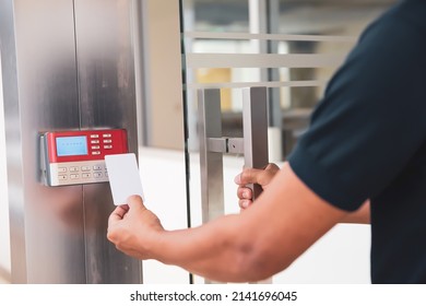 Proximity card reader door unlock, Close up hand security man using ID card scanning at the access control system for identity verification to open the door or for security safety or check attendance.