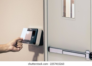 Proximity card reader door unlock, Hand security man using ID card on fingerprint scanning access control system for identity verification to open the door or for security safety or check attendance. - Shutterstock ID 2257415263