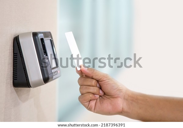 Proximity card reader door unlock, Hand\
security man using ID card on fingerprint scanning access control\
system for identity verification to open the door or for security\
safety or check\
attendance.