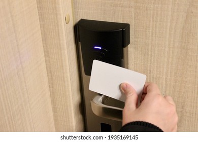 Proximity Key Card To Authenticate For Unlock Door. Hand Holding Key Card.Key Card Hotel Room Access