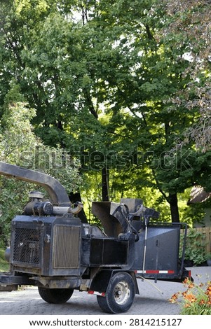 Pruning work with a tree chipper.