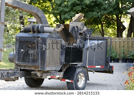 Pruning work with a tree chipper.