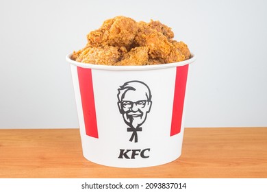 Pruszcz Gdanski, Poland - August 23, 2021: Lots of KFC chicken hot wings in bucket of KFC (Kentucky Fried Chicken) fast food. Iconic bucket with Harland Sanders icon.