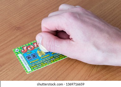 Pruszcz Gdanski, Poland - March 8, 2019: Scratching A Scratch-off Lotto Lottery Ticket.