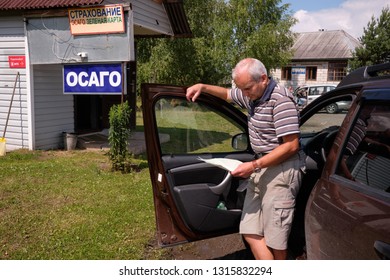 Pskov Region. Russia - July 5, 2018: Point Of Sale Of Green Car Cards And Insurance CTP On The Border With The Republic Of Belarus. Man Examines Insurance Documents.