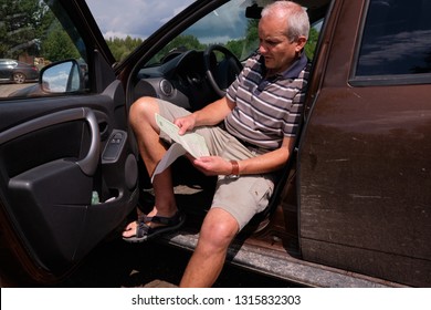 Pskov Region. Russia - July 5, 2018: Point Of Sale Of Green Car Cards And Insurance CTP On The Border With The Republic Of Belarus. Man Examines Insurance Documents.