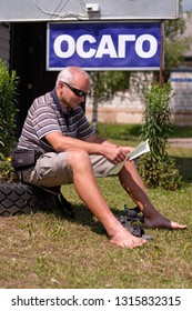 Pskov Region. Russia - July 5, 2018: Point Of Sale Of Green Car Cards And Insurance CTP On The Border With The Republic Of Belarus. Man Examines Insurance Documents.