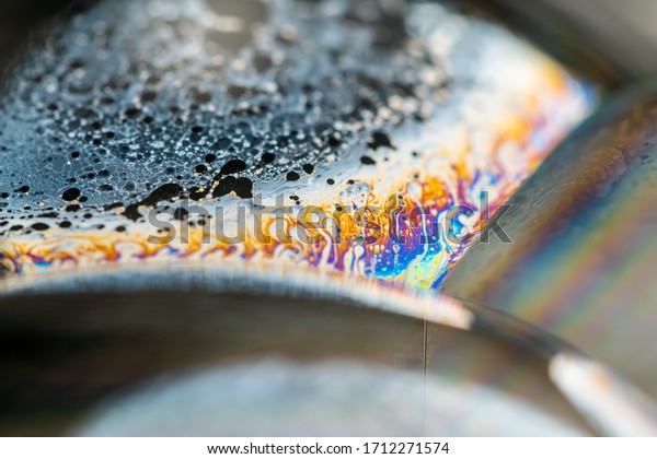 Psychedelic abstract planet from soap bubble,\
Light refraction on a soap bubble, Macro Close Up in soap bubble.\
Rainbow colors on a black background. Model of Space or planets\
universe cosmic\
galaxy.