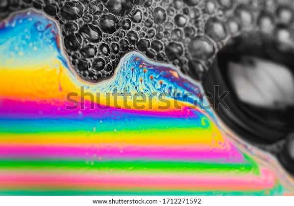 Psychedelic abstract planet from soap bubble,\
Light refraction on a soap bubble, Macro Close Up in soap bubble.\
Rainbow colors on a black background. Model of Space or planets\
universe cosmic\
galaxy.