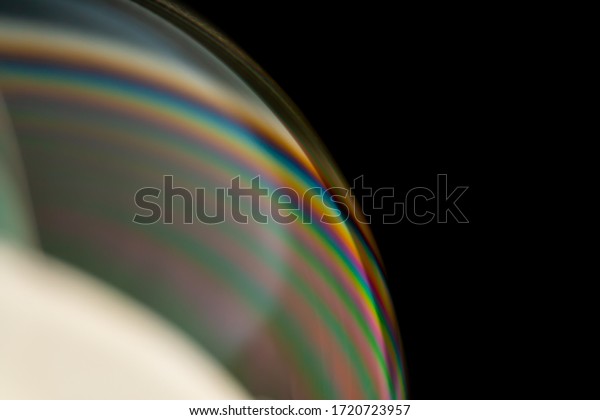 Psychedelic abstract planet from soap bubble,\
Light refraction on a soap bubble, Macro Close Up moving particles\
Rainbow colors on a black background. Model of Space or planets\
universe cosmic\
galaxy.