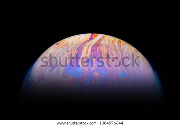 Psychedelic abstract\
planet-like soap bubble, light refraction on a soap bubble, colors\
in soap bubble.