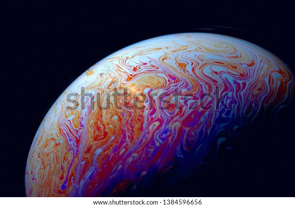 Psychedelic abstract
planet-like soap bubble, light refraction on a soap bubble, colors
in soap bubble.