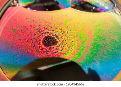 Psychedelic patterns formed on the surface of soap bubbles