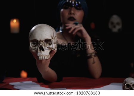 Psychic speaking to the dead using human skull in ritual. Stock photo © 