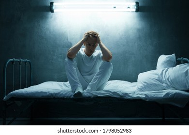 Psycho Man Sitting In Bed, Dark Room On Background