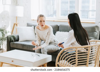 psychological consultation young Asian specialist psychologist or coach conducts a session for a patient of a young woman, problem solving, mental health - Shutterstock ID 2184656375