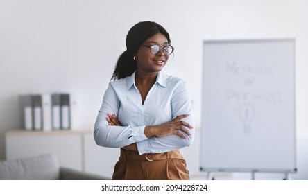 Psychological Education. Successful Black Business Coach Giving Personal Growth Training, Posing With Crossed Arms At Office, Panorama. Confident African American Tutor Teaching Psychology Course