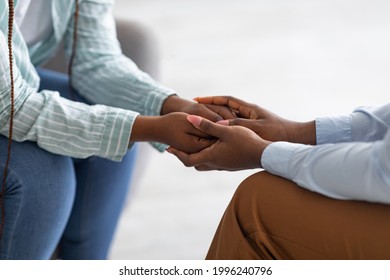 Psychological Support. Psychotherapist Offering Help To Young Woman, Holding Her Hands Indoors, Closeup View. Unrecognizable Psychiatrist Providing Assistance To Female Patient