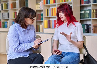 Psychologist, College Counselor Counseling Teenage Student In Library, Office