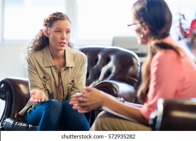 Psychologist having session with her patient in office - Shutterstock ID 572935282