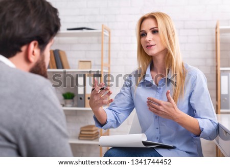 Psychologist having session with her patient in office, giving him advice about his life