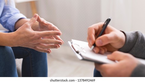 Psychologist listening to his patient and writing notes, mental health and counseling concept, panorama, copy space - Shutterstock ID 1378492469