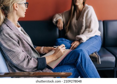 The psychologist makes a social survey of the reference group. A professional is talking to a client. Informal communication at the interview, business consultant writes notes in a notebook. - Shutterstock ID 2109278048