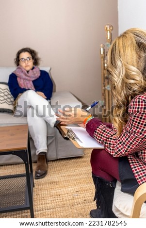 Psychologist making notes during therapy session