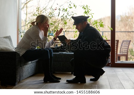 Psychologist of the police talking to a victim after a burglary with theft