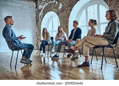 Psychologist Speaking With Patients At Meeting, Addiction Treatment, Coach Training Staff, Team Building Activity Concept. Low Angle View