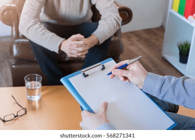 Psychologist Taking Notes During Psychotherapy Session