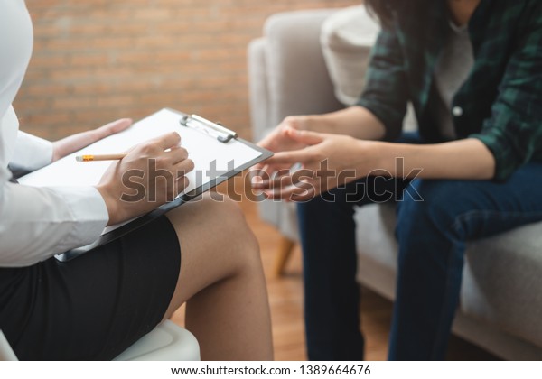 psychologist talking with depressed patient\
about mental\
condition.