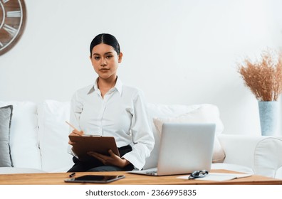 Psychologist woman in clinic office professional portrait with friendly smile feeling inviting for patient to visit the psychologist. The experienced and confident psychologist is uttermost specialist - Shutterstock ID 2366995835