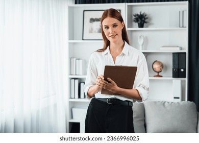Psychologist woman in clinic office professional portrait with friendly smile feeling inviting for patient to visit the psychologist. The experienced and confident psychologist is utmost specialist - Shutterstock ID 2366996025
