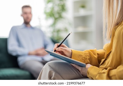 Psychologist woman doctor making notes consulting male patient in bright office, healthcare concept, hands section - Shutterstock ID 2199376677