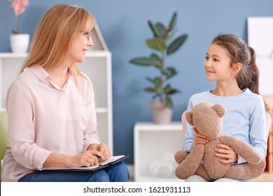 Psychologist working with little girl indoors - Shutterstock ID 1621931113