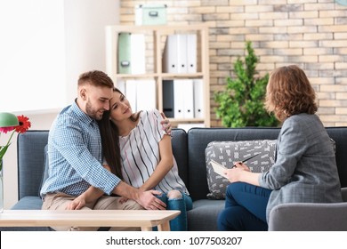 Psychologist working with married couple in office - Shutterstock ID 1077503207