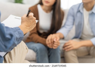 Psychology, depression asian young couple, patient consulting problem mental health with psychologist, psychiatrist at clinic together, husband encouraging by holding hand of wife, therapy health care - Shutterstock ID 2169719345