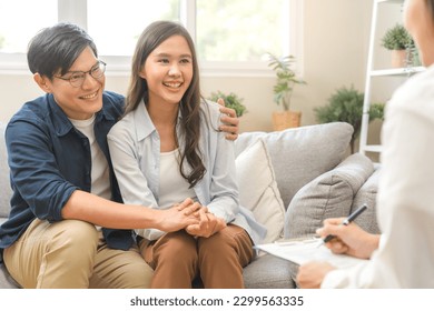Psychology, depression asian young couple love, patient consulting problem mental health with psychologist, psychiatrist at clinic together, husband embracing shoulder of wife, therapy health care. - Shutterstock ID 2299563335