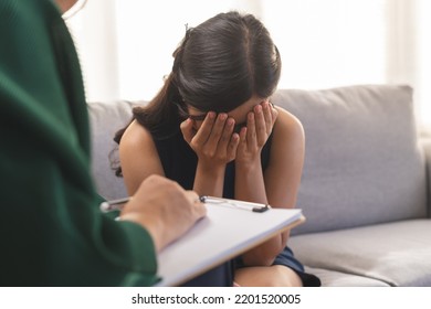 Psychology, depression. Sad asian young woman crying about break up or divorce, consulting with senior psychologist while psychiatrist counseling mental health patient at clinic. Encouraging, empathy. - Shutterstock ID 2201520005