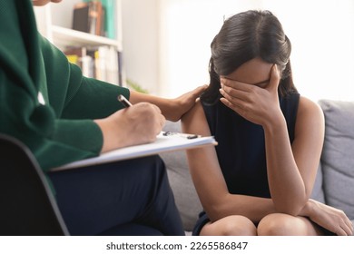 Psychology, depression. Sad asian young woman crying about break up or divorce, consulting with senior psychologist, psychiatrist counseling with mental health patient at clinic. Encouraging, empathy. - Shutterstock ID 2265586847