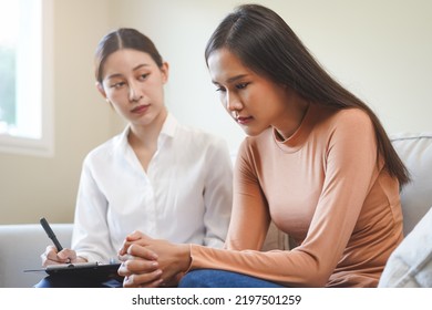 Psychology, Depression. Sad, Suffering Asian Young Woman, Consulting With Psychologist, Psychiatrist While Patient Counseling Mental Problem With Doctor At Clinic. Encouraging, Therapy, Health Care.