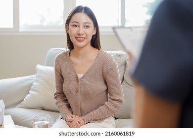 Psychology, Depression. Smile Asian Young Woman Patient  Mental Explained Symptom With Psychologist, Psychiatrist While Doctor Woman Taking Notes At Clinic. Encouraging, Therapy.