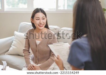 Psychology, depression. smile asian young woman patient mental explained symptom with psychologist, psychiatrist while doctor woman taking notes at clinic. Encouraging, therapy.