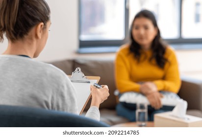psychology, mental therapy and people concept - close up of woman psychologist and patient at psychotherapy session - Shutterstock ID 2092214785